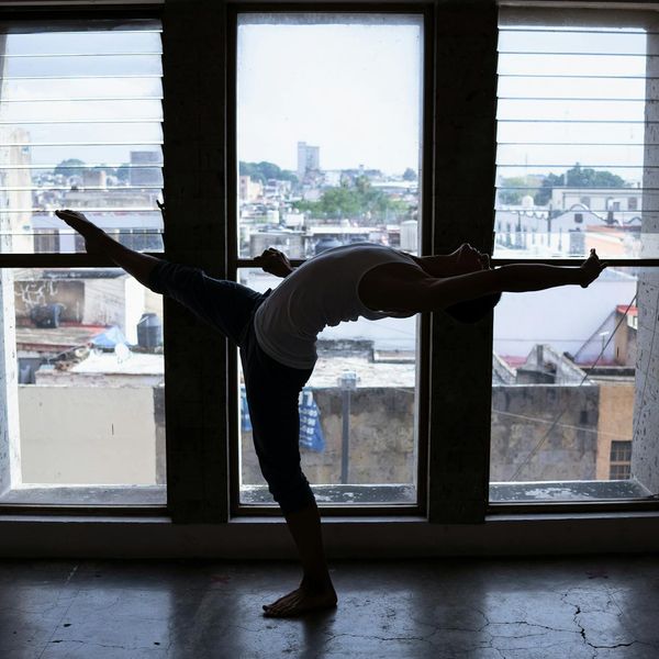 Person in a dynamic movement pose showing flexibility and flow.